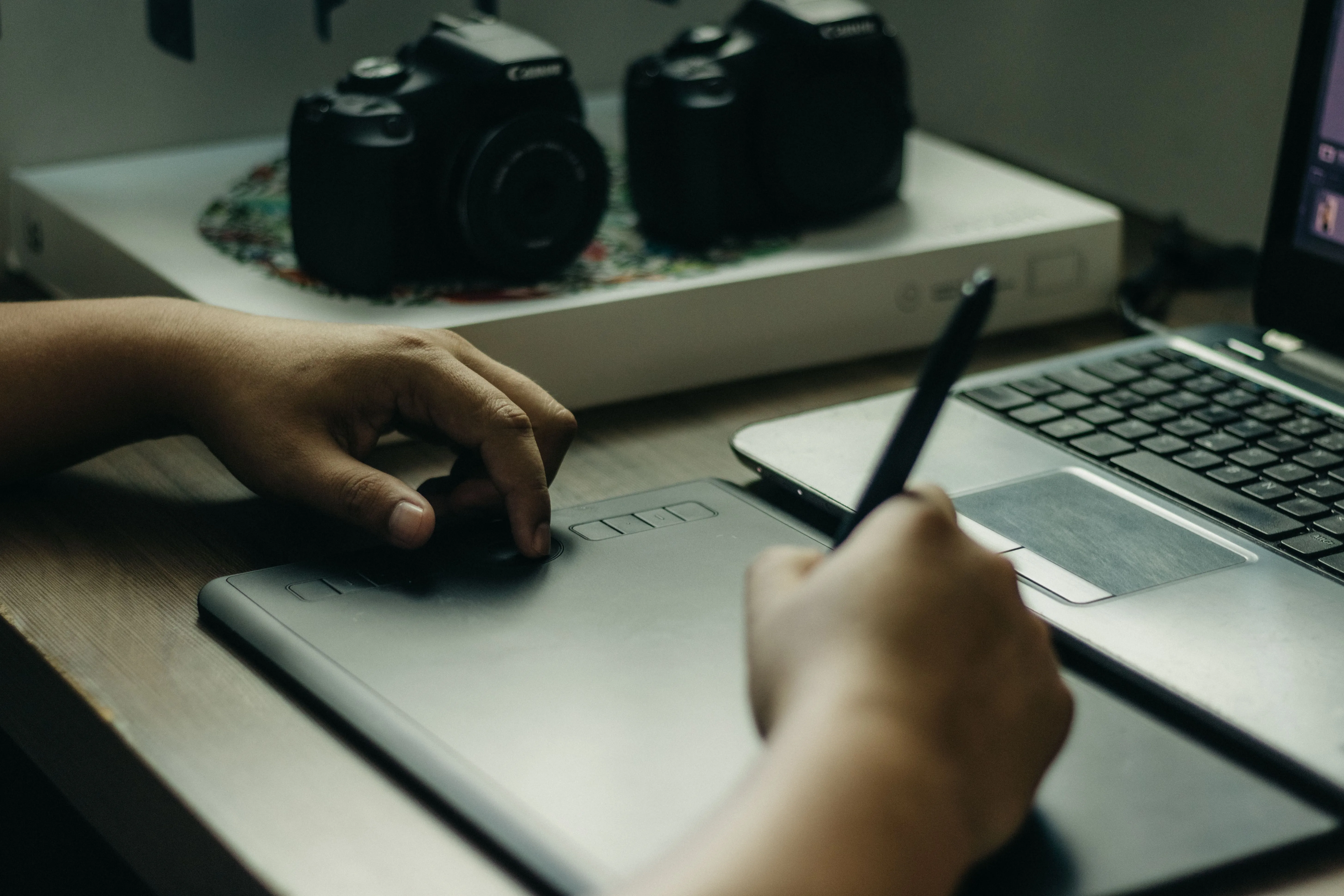 A designer crafting brand assets on a graphics tablet for a Miami business